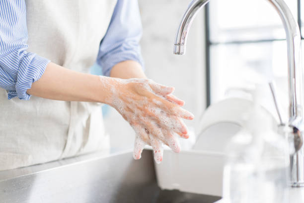 istock A woman is washing her hands in the kitchen. 1669474740