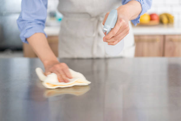 istock A woman is wiping the kitchen counter. 1669475297