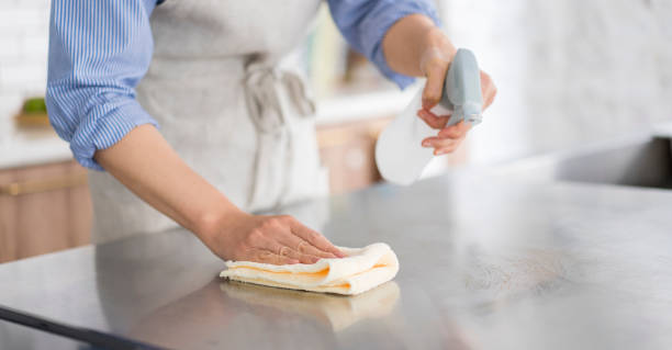 istock A woman is wiping the kitchen counter. 1669475806