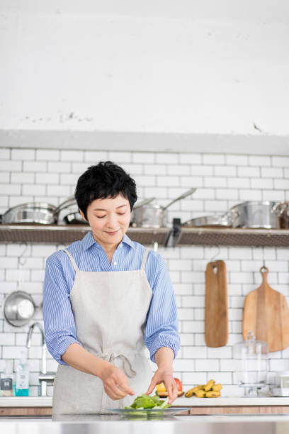 istock A woman is serving a salad. 1669476321