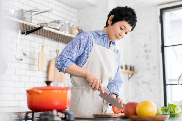 istock An Asian woman is cooking. 1669477369