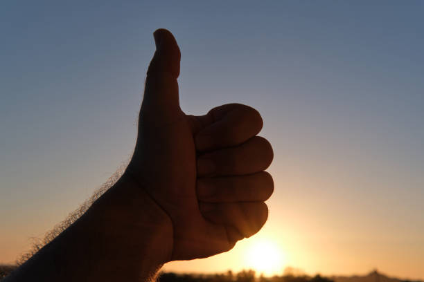istock Thumb up against the sun at dawn 1669498197