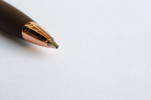 Close-up of signature pen on white notepad with customizable space for text or ideas.