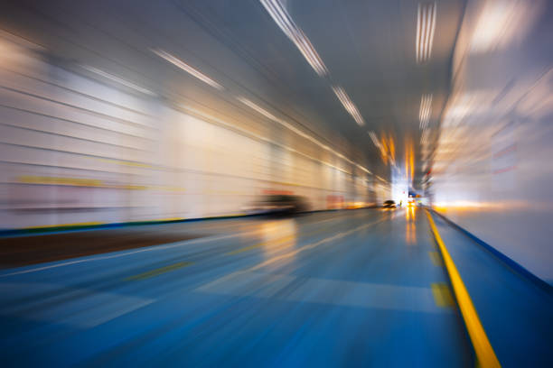 Using a zoom blur effect for dramatic emphasis, the photograph captures the first cars boarding a ferry. The blurring technique creates a dynamic sense of motion and urgency, suggesting the beginning of a voyage or a new chapter. It evokes the anticipation and excitement inherent in travel, making for a captivating image that speaks to the transient nature of journeys.