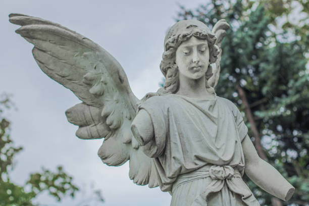 istock Sad antique statue in a cemetery 1669608008
