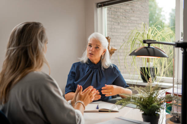 Counselling session between female accountancy specialist and client stock photo