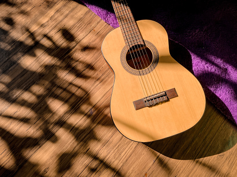Classical guitar on wooden background. Copy Space. Music Instruments design.