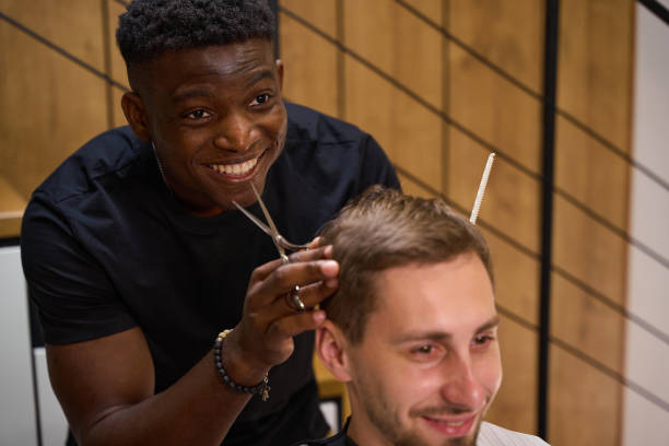 istock Friendly African American guy makes a haircut for a client 1669670229