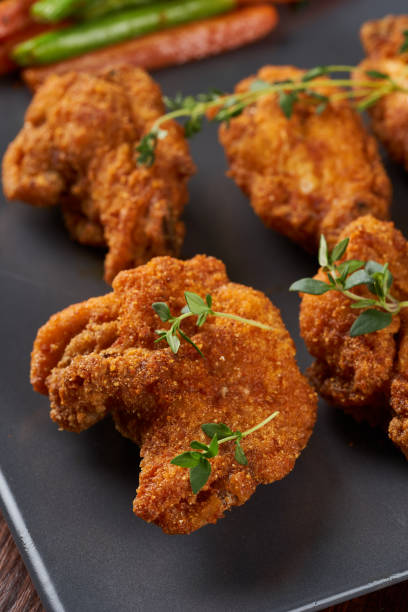 istock Fried chicken wings with sauteed vegetables 1669690644