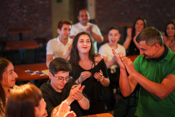 istock Audience clapping hands to the speakers on the stage at the conference 1669807639