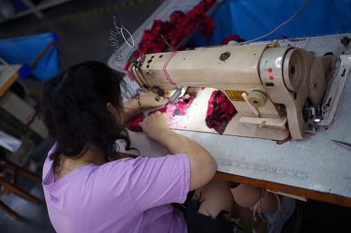 Female worker using sewing machine
