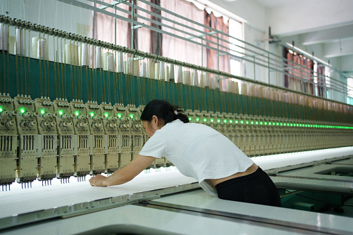 Worker inspecting loom