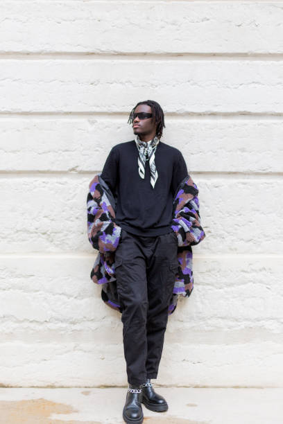 istock Young black man walking around town in fall 1669848419