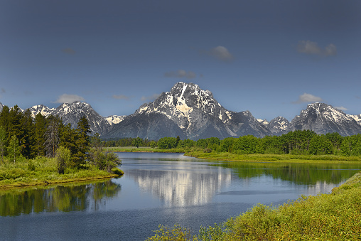 Snake River in Grand Teton National Park in northwestern Wyoming. USA - the peaks of the snow-capped mountains are reflected in the surface of the river