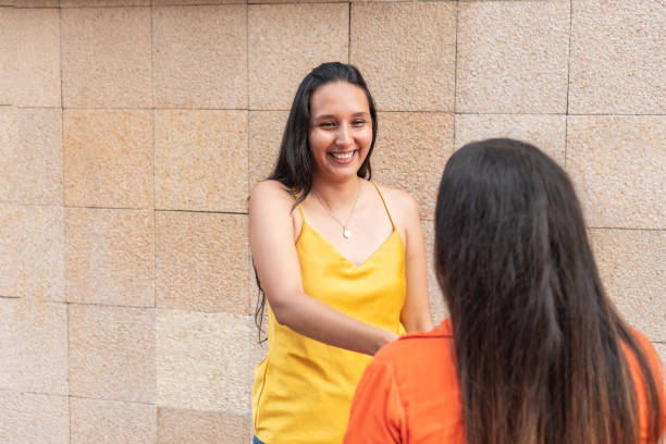 istock Friends looking at each other and smiling in the open air 1669864152