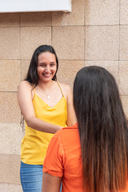 istock Friends looking at each other and smiling in the open air 1669864155