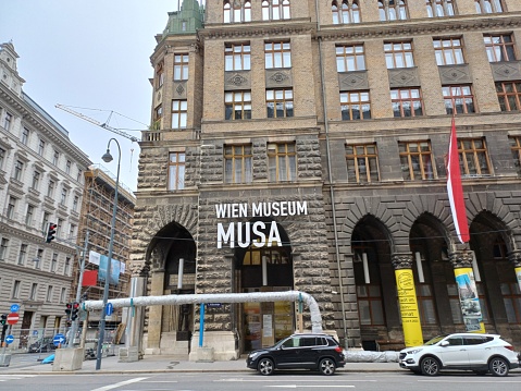 Vienna, Austria - June 8, 2023: MUSA Wien Museum with flags on Rathausstrasse Street in city center\nof Vienna, Austria. Building architecture cityscape and view on road.