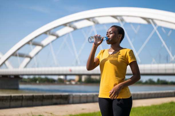 istock Woman drinking water while  exercise outdoor 1669880434