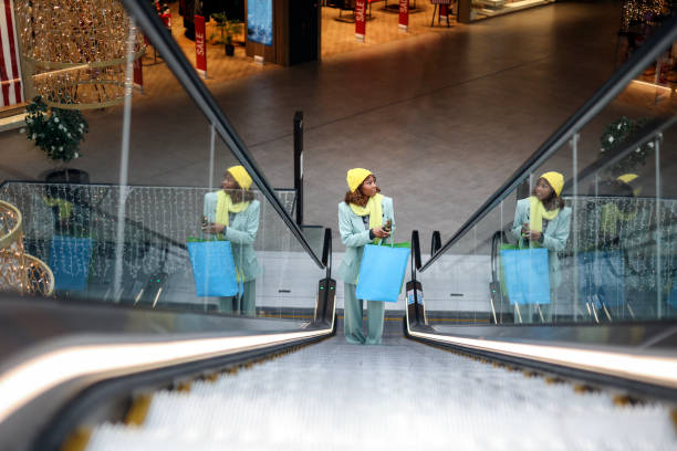 istock Young African woman using an escalator 1669882694