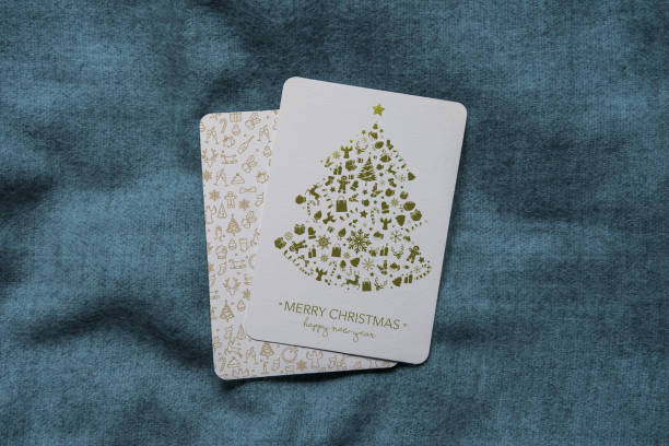 Close-up of blank greeting card among Christmas decorations on beige background