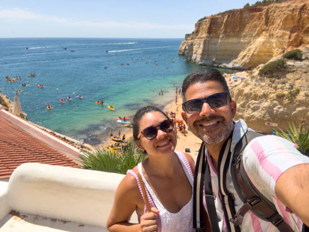 istock Couple taking a selfie on Benagil beach 1669886034