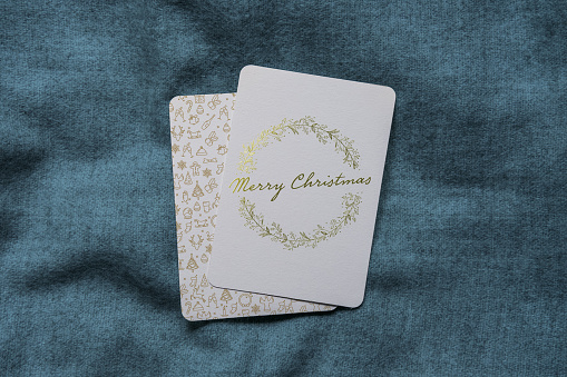 Christmas cards with gilded hand drawn wreath with Christmas wishes