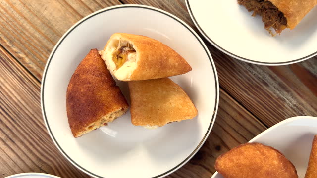 Tabletop view of various empanada dishes