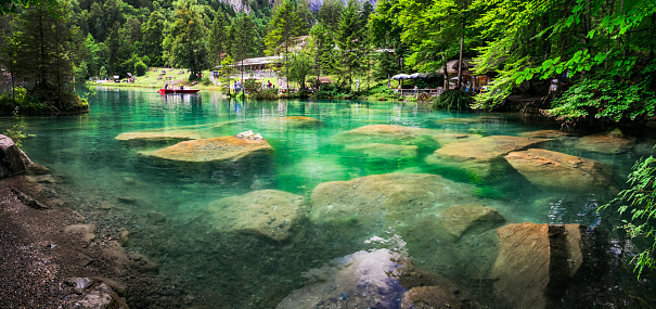 Blausee - one of the most beautiful lake in Europe, located in Switzerland, canton Berne. famous with emerald clear and trasparent waters , surrounded by Alps mountains . Popular tourist destination