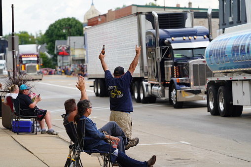 Waupun, Wisconsin USA - August 12th, 2023: Local families came out to spectate and cheer on the truckers in The Truck - n - Show parade.
