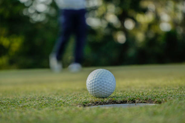 istock Golfers are putting golf in the evening golf course golf backglound. 1669927444