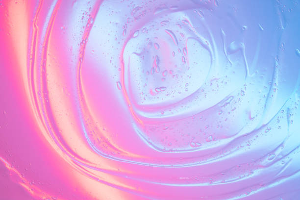istock Transparent gel with air bubbles in neon lighting. Abstract multicolored background 1669929565