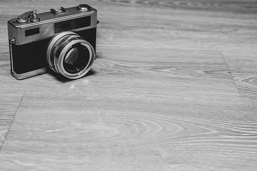 Vintage film camera on wood background,copyspace