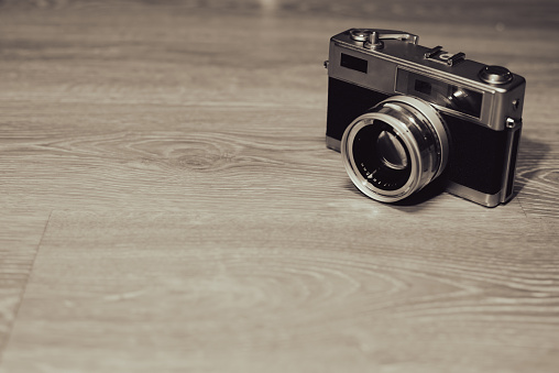 Vintage film camera on wood background,copyspace