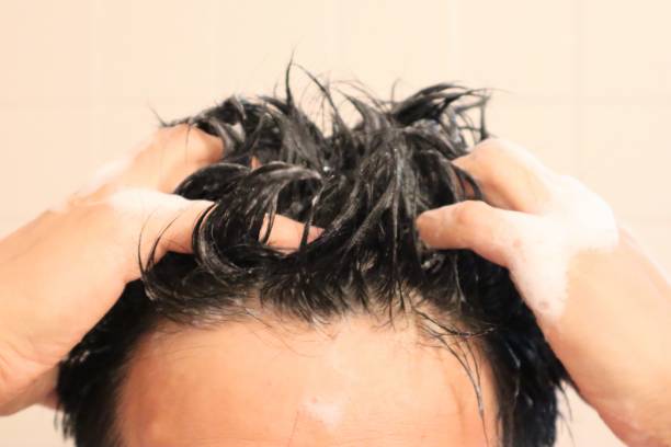 istock Close-up of a man shampooing 1669934970