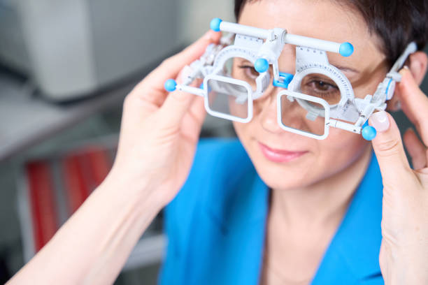 Optometrist hands putting trial lens frame with polarizing filters on woman face