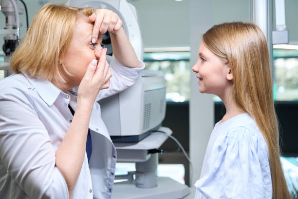 istock Experienced female ophthalmologist teaching child how to use corrective lenses 1669936221