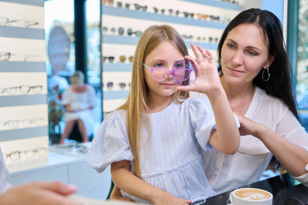 istock Focused child choosing lenses for her spectacles 1669937204