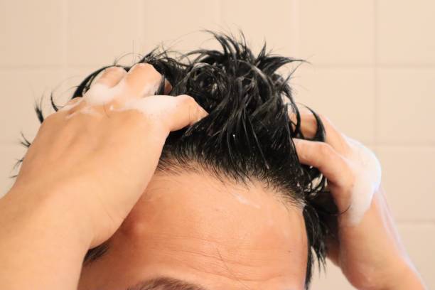 istock Close-up of a man shampooing 1669937951