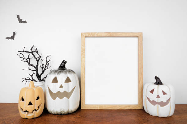 istock Halloween mock up wooden frame on a wood shelf with black branches and jack o lantern decor 1670043398