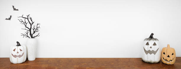 istock Halloween jack o lantern and spooky branch shelf decor against a white wall banner background 1670043417