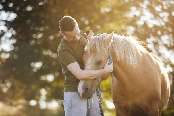 istock Man embracing of theraphy horse 1670049819