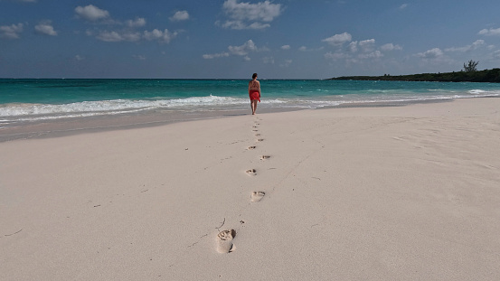 Low angle view past her footprints