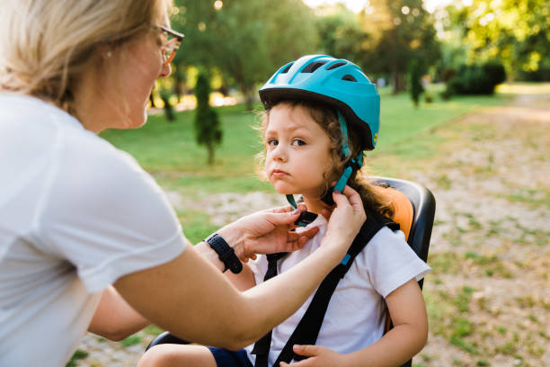 istock Mother helping son wearing helmet for cycling 1670057976