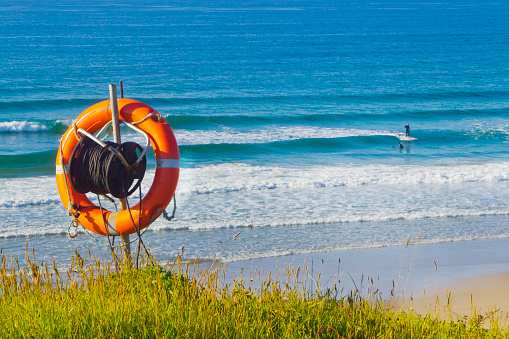 Lifebuoy hanging in front of a wild beach in A Mariña, Lugo province, Galicia, Spain, part of the \