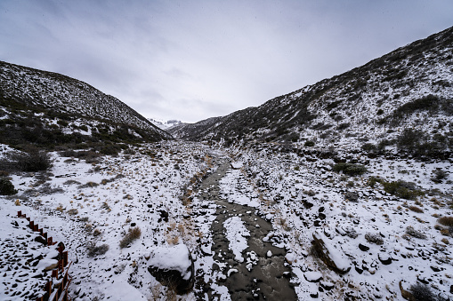 River flowing down snowy steppes of Patagonia at Jeinimeni National Reserve