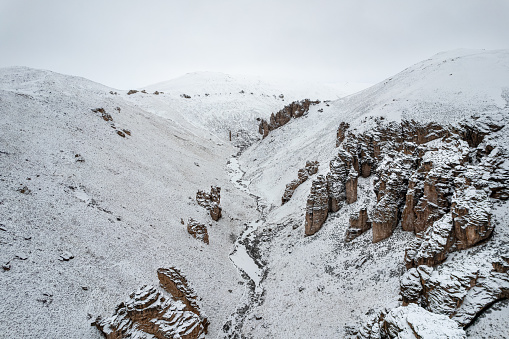 Snowy valley surrounded by awe rock formations at Jeinimeni National Rerserve in Patagonia