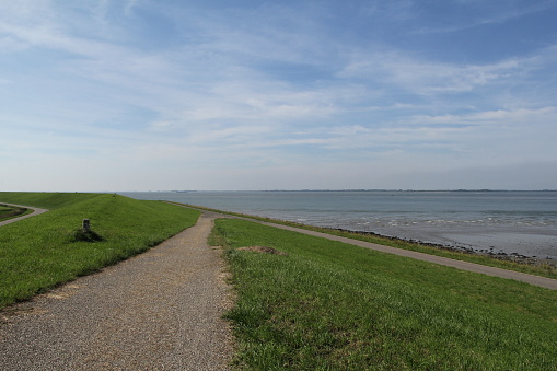 a dike crossing at a delta dike at the dutch coast in zeeland in front of the western scheldt sea