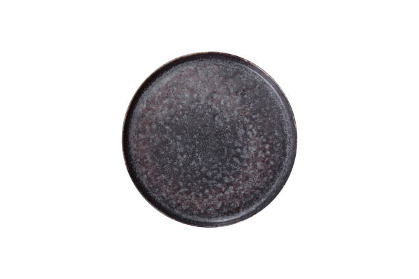 istock Black plate on a black background. Flat lay, top view, copy space 1670230023