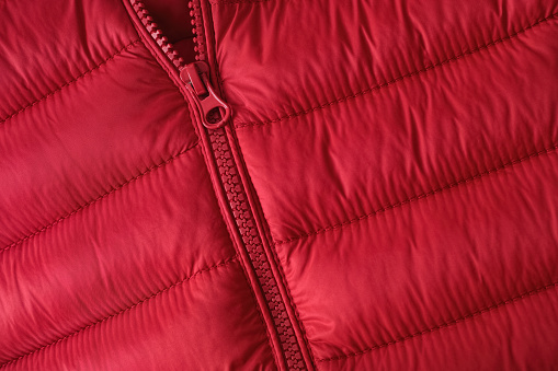 Closeup shot of a zipper on a red jacket. Close up.