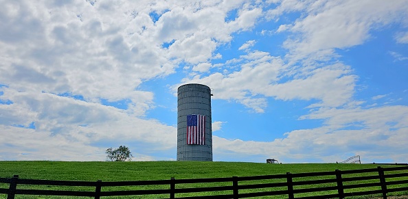 Silo in East Tennessee with American flag hanging on it.